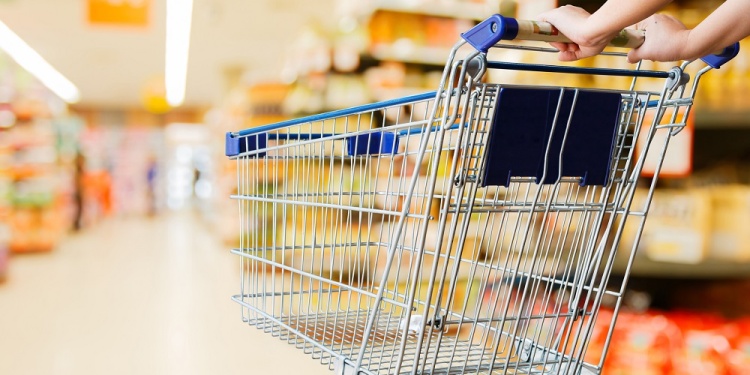 woman pushing shopping cart in supermarket