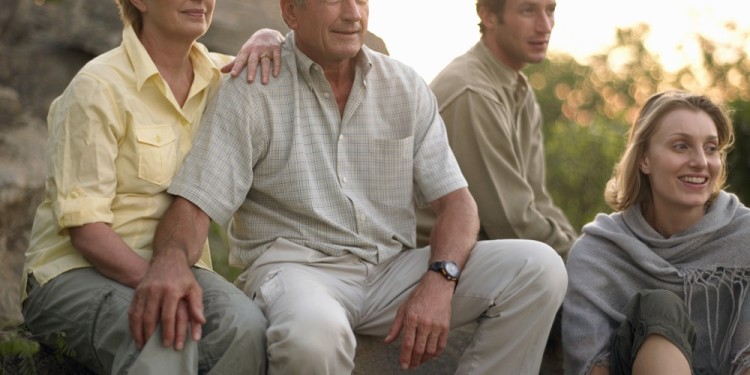 Two couples sitting outdoors, smiling