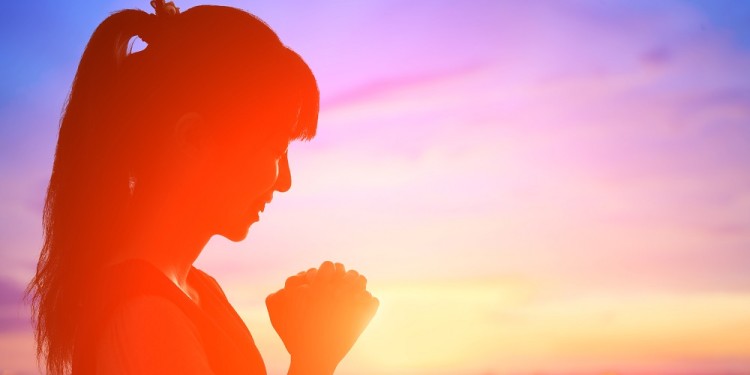 young woman pray pious with sunrise, asian