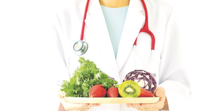 Doctor holding fresh fruit and vegetable, Healthy diet, Nutrition food as a prescription for good health. (Selective Focus)