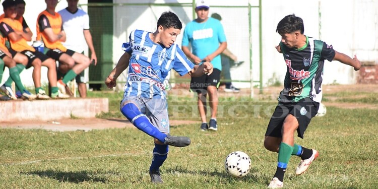 INTENTA EL CAÑO. El jugador de Luz y Fuerza busca hacer pasar la pelota entre los pies de un rival de El Brete.