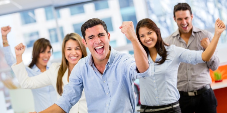 Business team celebrating a triumph with arms up