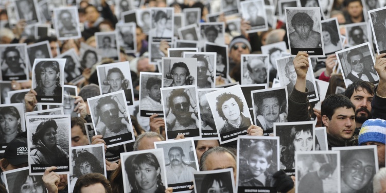 18 Jul 2012, Buenos Aires, Argentina --- People during the eighteenth anniversary ceremony of the bombing of the AMIA Jewish Mutual, holding portraits from the killed people in the attack, Buenos Aires, Argentina, July 18, 2012. The Argentina Jewish Mutual Association (AMIA) called on the Argentine government to 'redouble' the demand to the UN to clarify the bombing of the Jewish institution in Buenos Aires, where 18 years ago 85 people killed. Photo: Sergio Goya/dpa/au --- Image by © Sergio Goya/dpa/Corbis